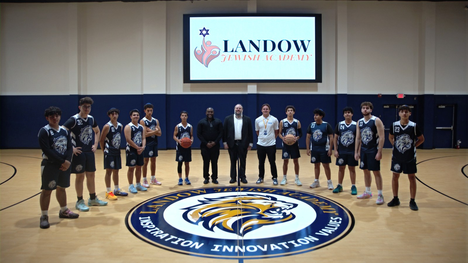Landow Lions basketball players and coaches together in the school gym