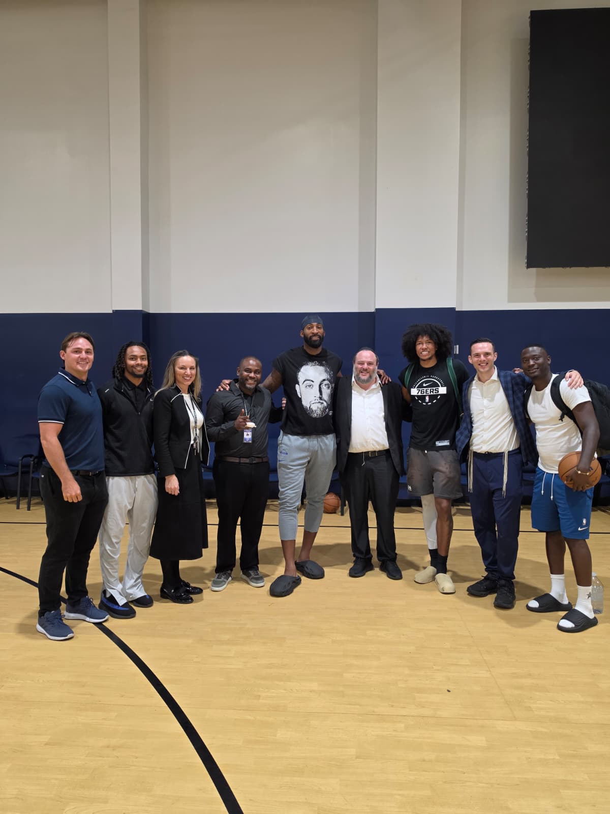 Basketball visitors and members of the Landow community together in the indoor gym